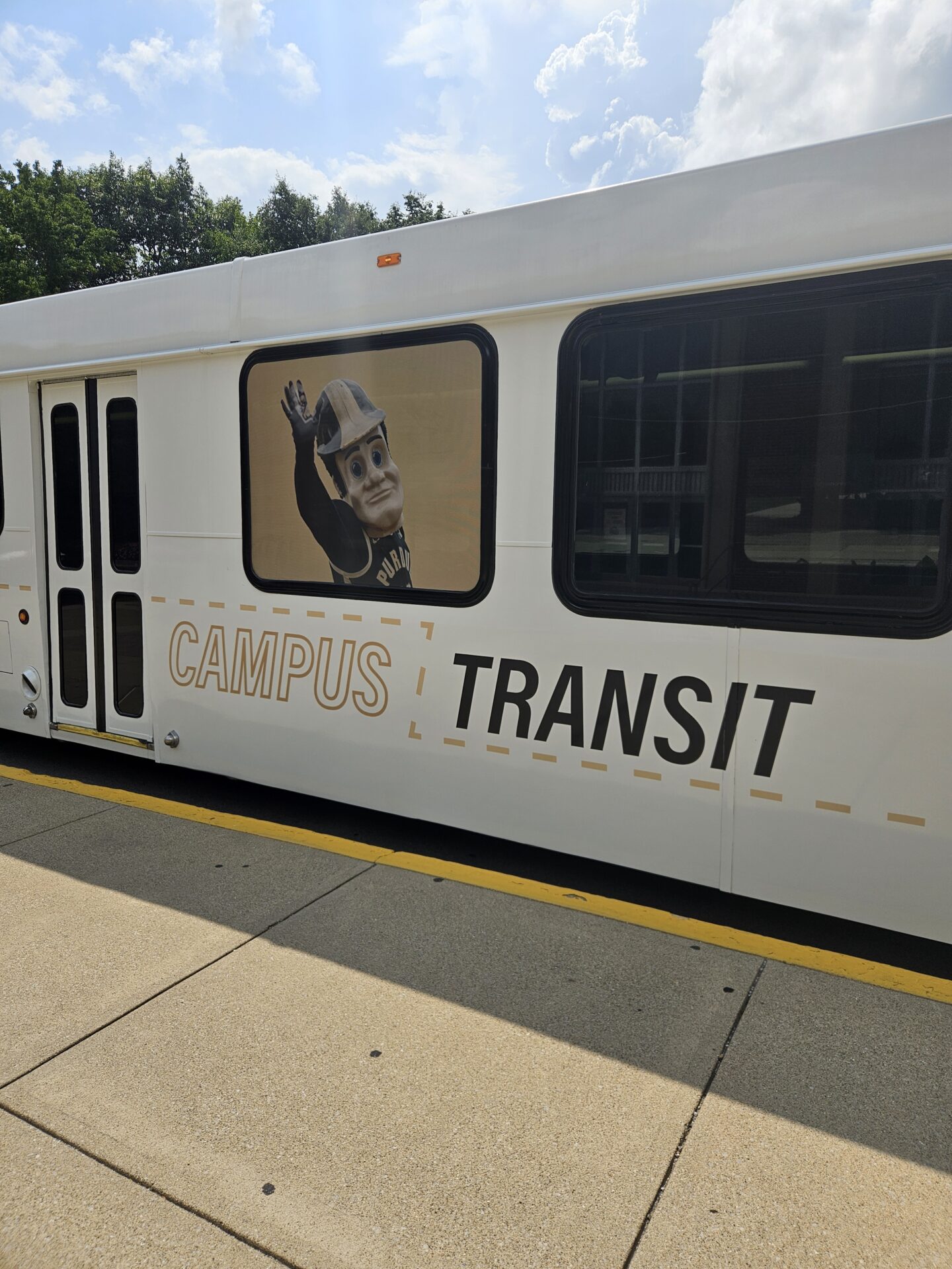 Campus Transit shuttle parked along curb