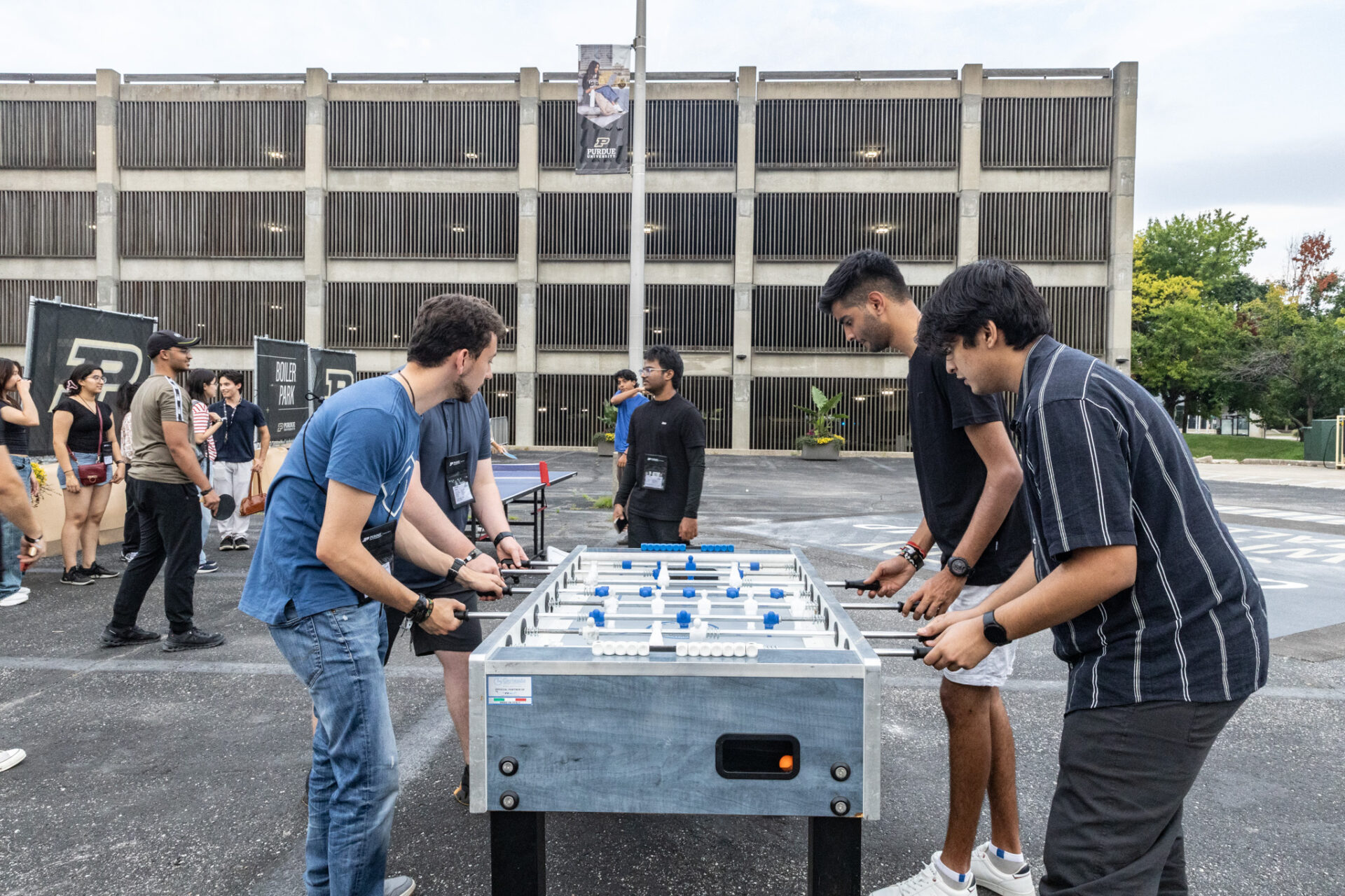 Students playing foosball outdoors during an event