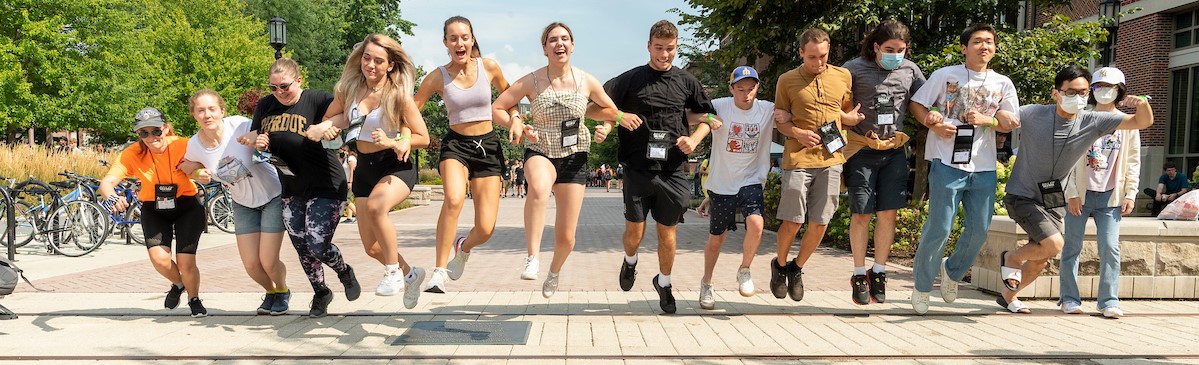 Banner image: students jump over the railroad tracks on Purdue's engineering row, a BGR tradition