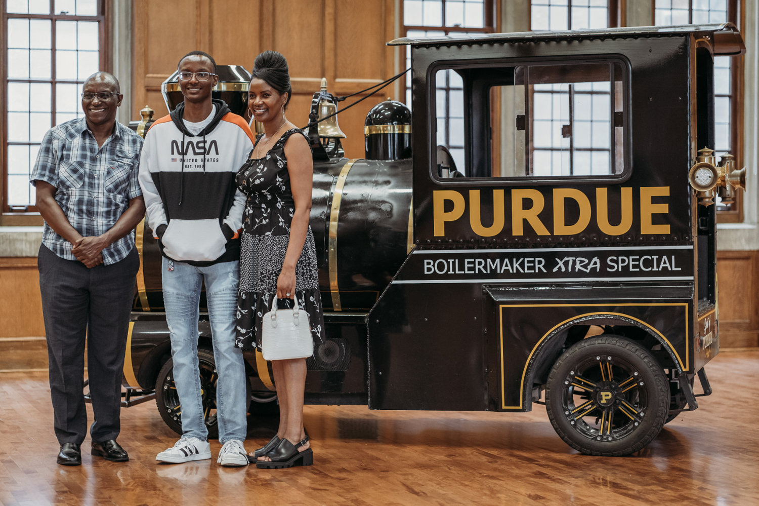 pictured: incoming student and his parents stand next to the boilermaker special train