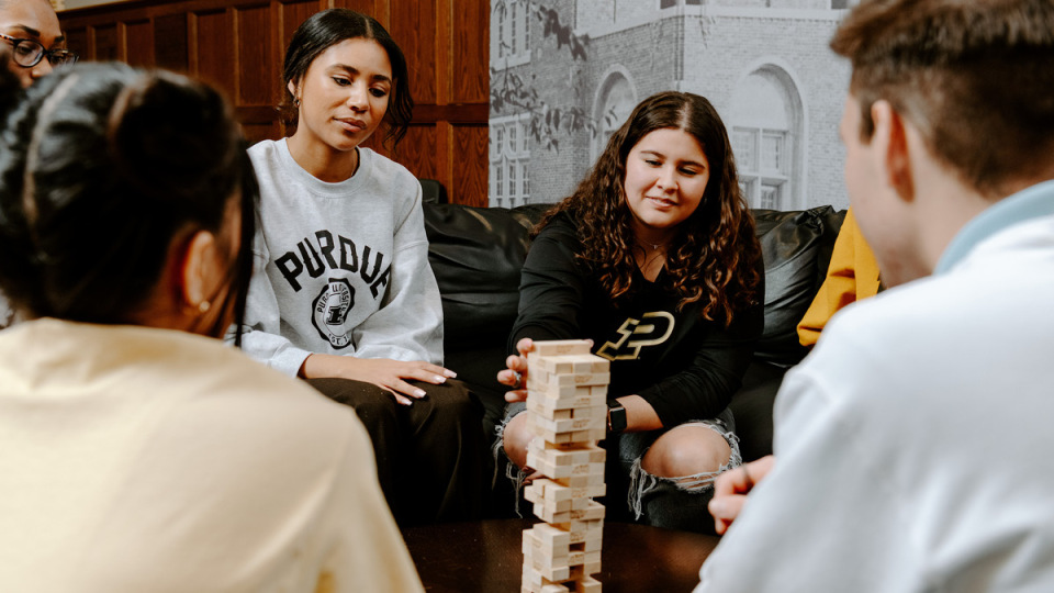 A group of students playing Jenga.