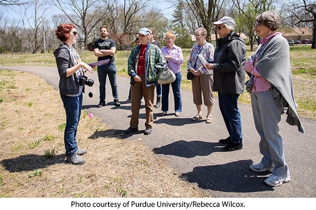A student intern from the Purdue Arboretum gives a tour of Horticulture Park to visitors. Photo courtesy of Purdue University/Rebecca Wilcox.