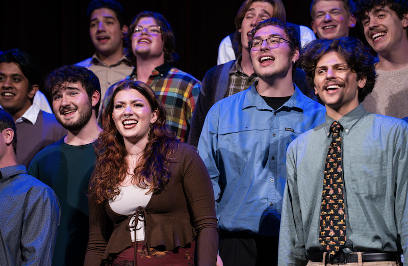 Group of students performing a song together on stage