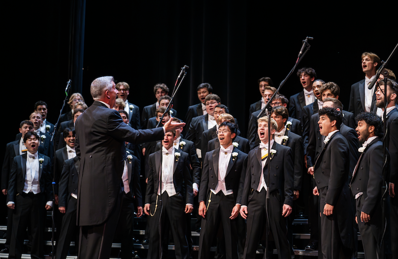 Group of students performing a song together on stage
