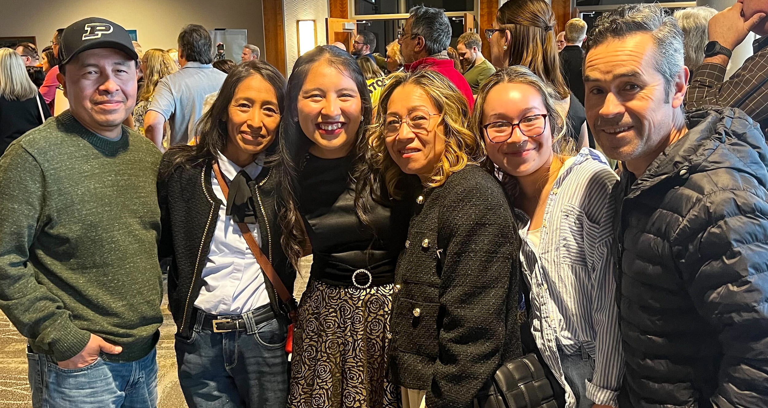 PMO student posing for a photo with their family