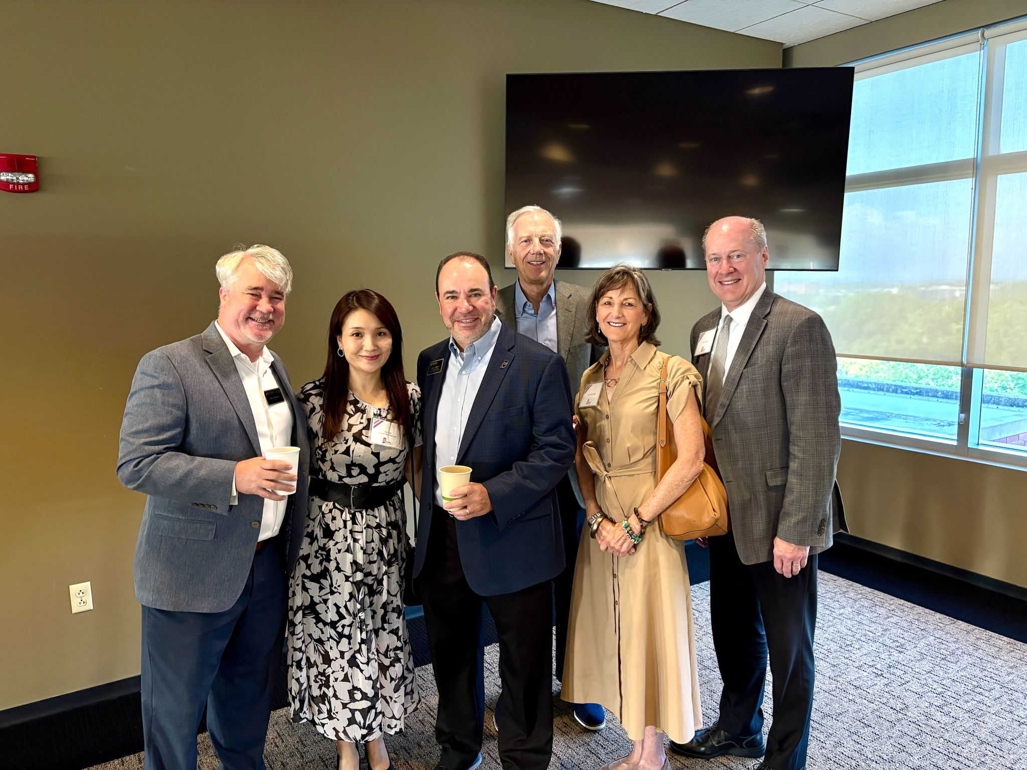 A group of university colleagues posing at a professional event