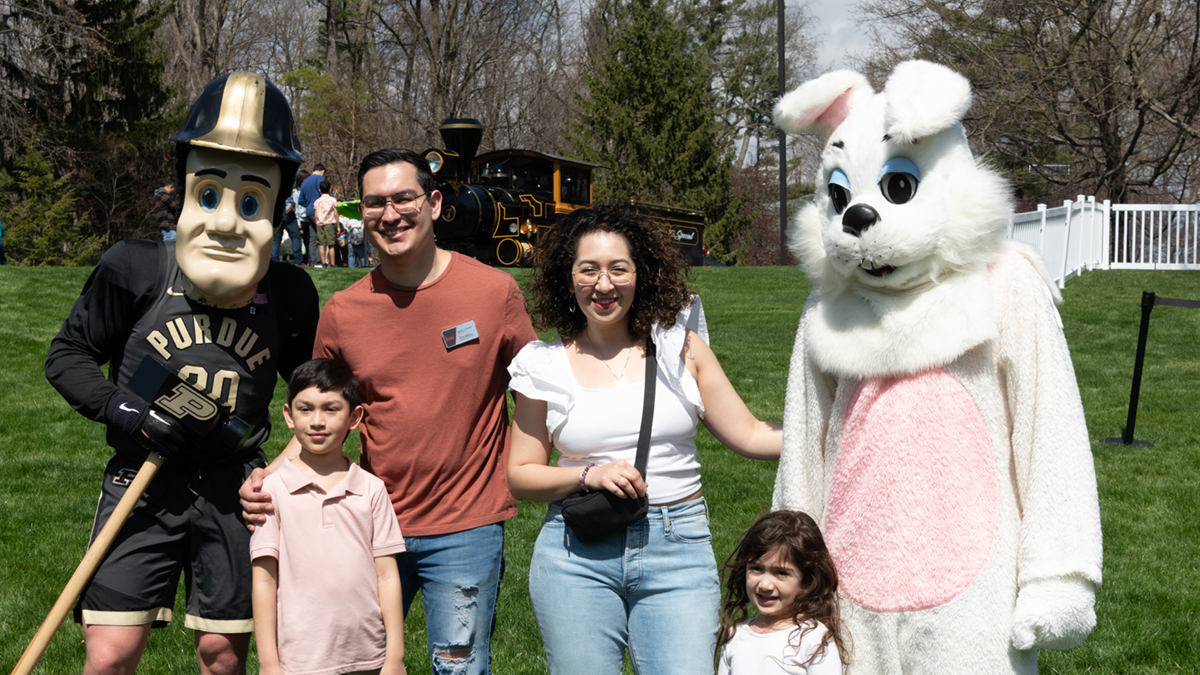 Family with the Easter bunny and Purdue Pete.