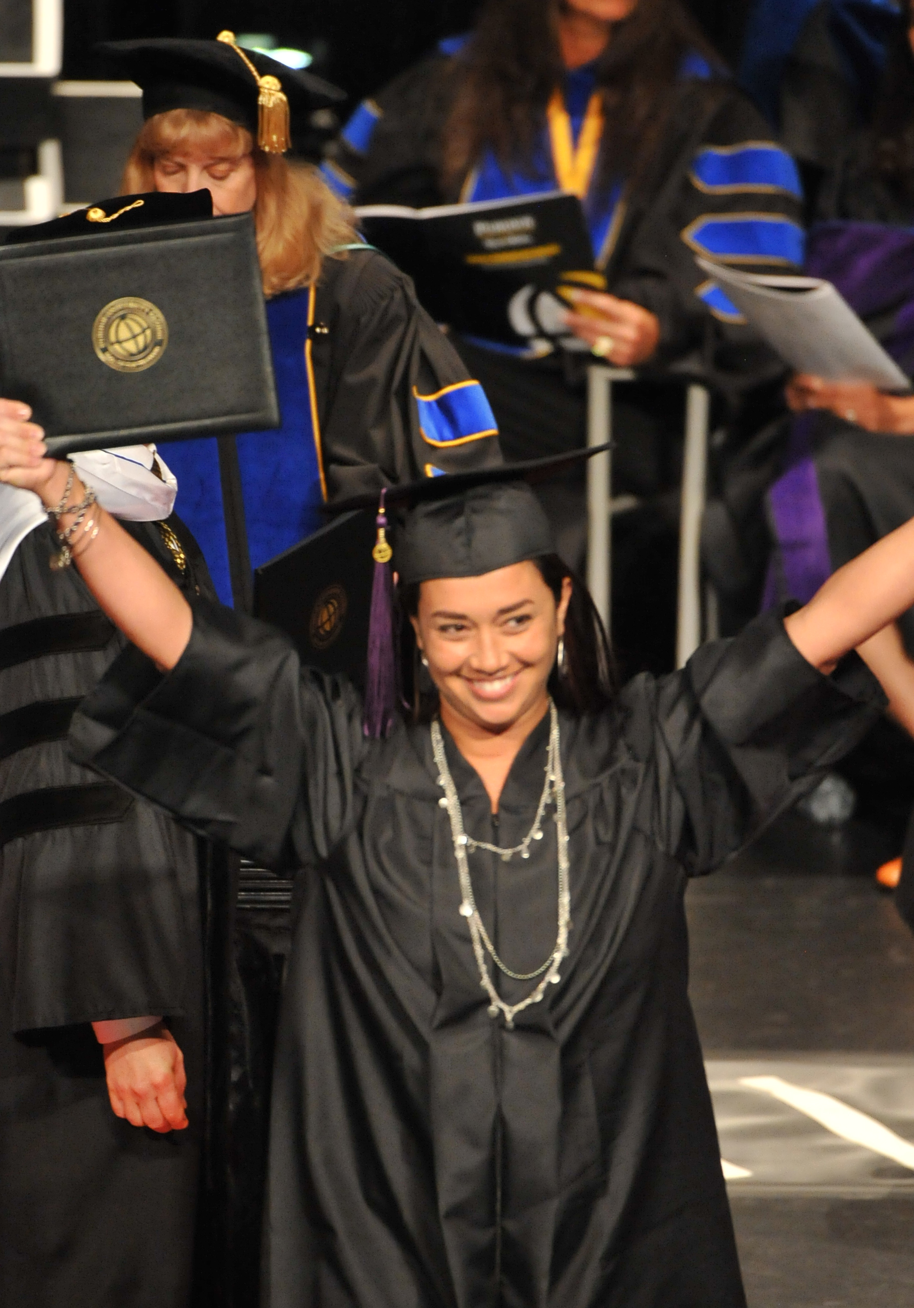 A Purdue University Global graduate celebrates receiving her diploma