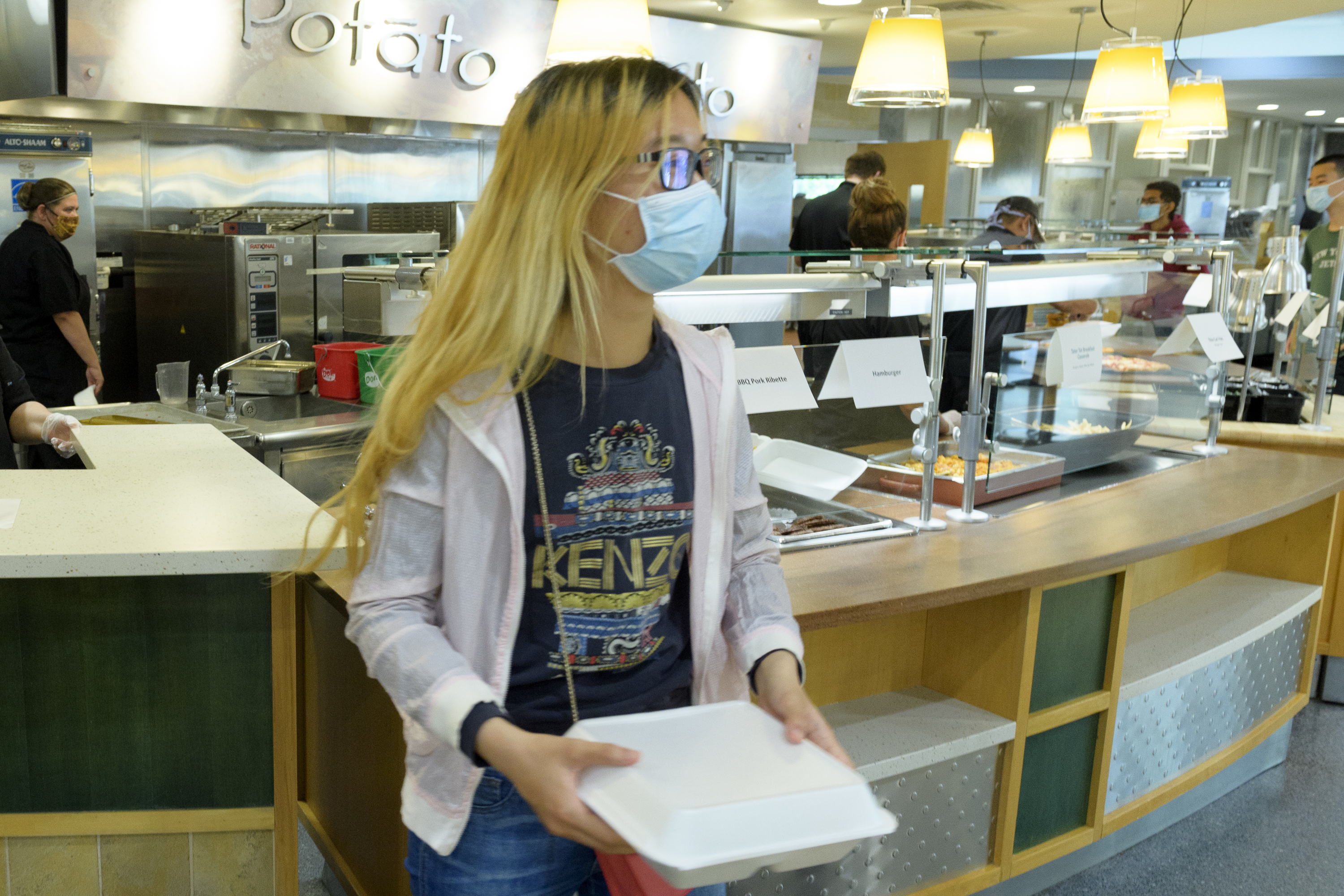 A student picks up a carryout meal.