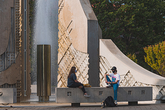 Students sit near the Engineering fountain.
