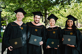 Students graduating and holding diplomas 