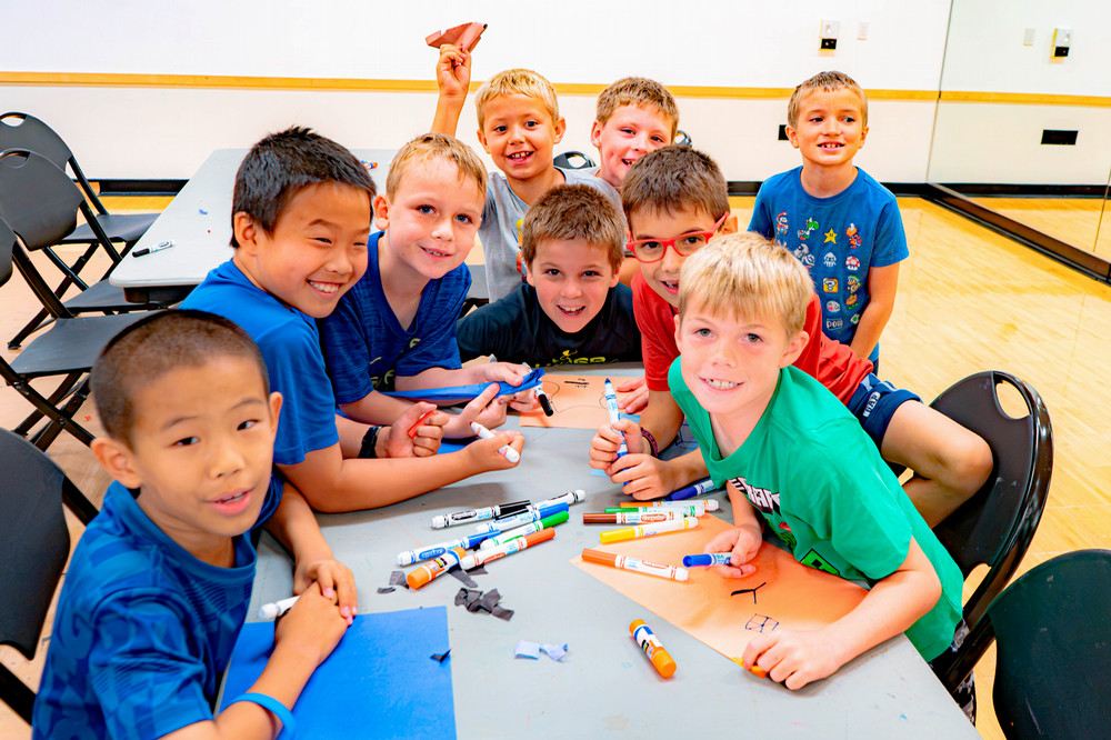 Boiler Kids Camp campers smiling at a crafts table