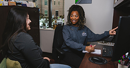 An advisor meets with a student in her office