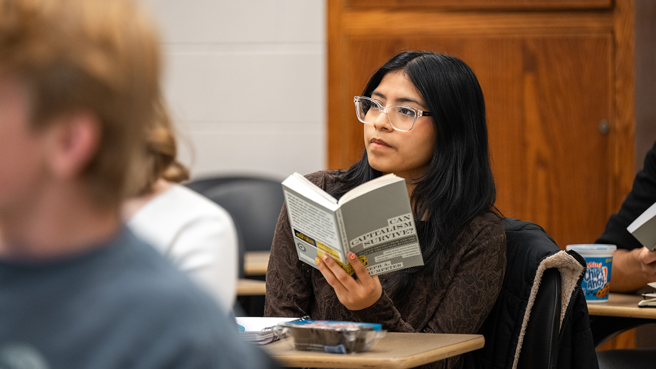 Student holding book in class