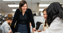 Woman helping students
