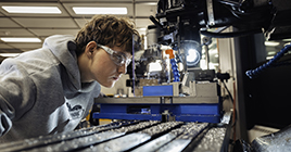Student working with a machine