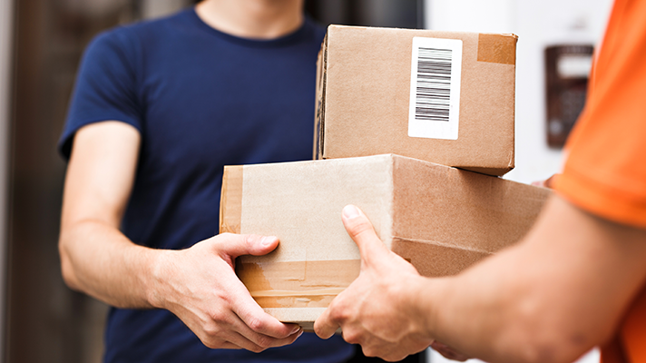 two people exchanging shipping packages