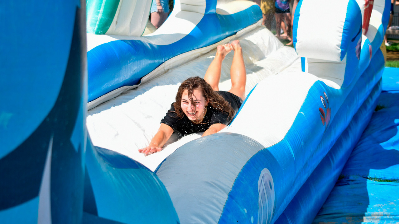 Students enjoy the water slide during RHA Day. 