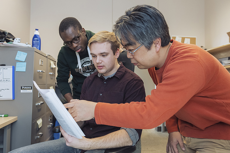 Professor Daisuke Kihara of Biological Sciences works with two graduate students.