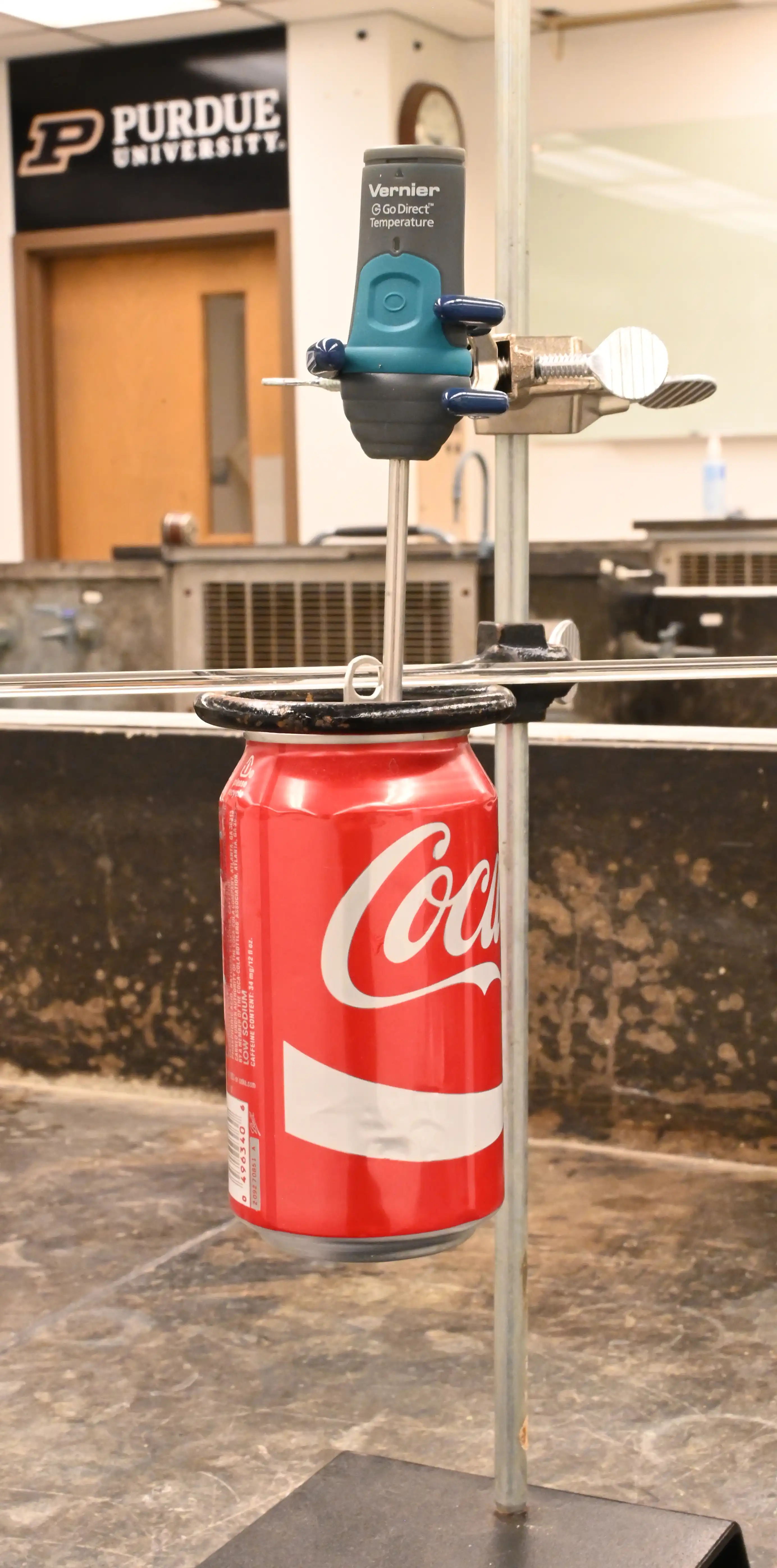Photo 1: Aluminum can is suspended from the ring stand.