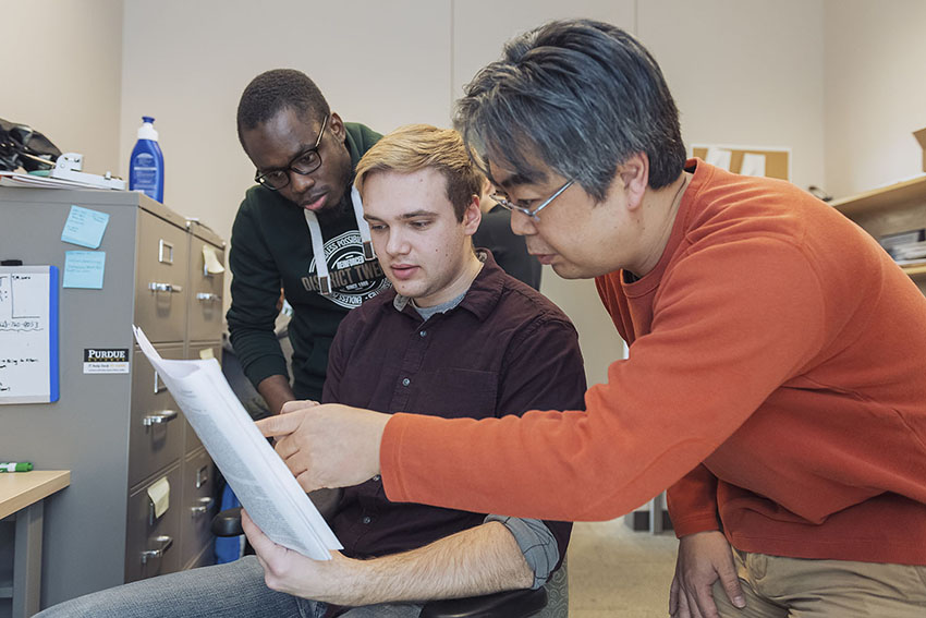 Daisuke Kihara, professor of biological sciences and computer science, and his graduate students discuss a bioinformatics project.