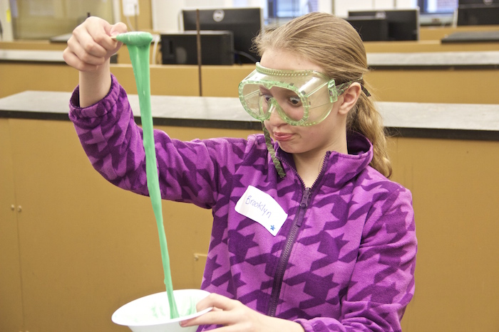A girl scout shows her slime.