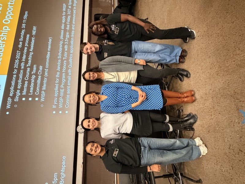WISP staff and leaders at an event with a guest speaker