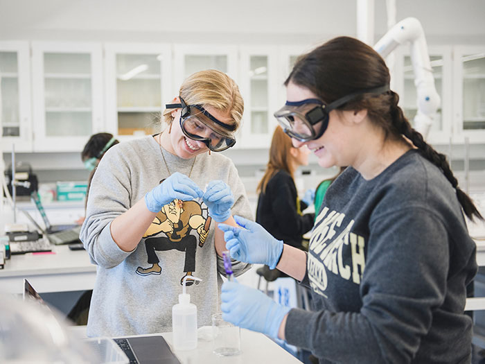 Two students doing lab work.