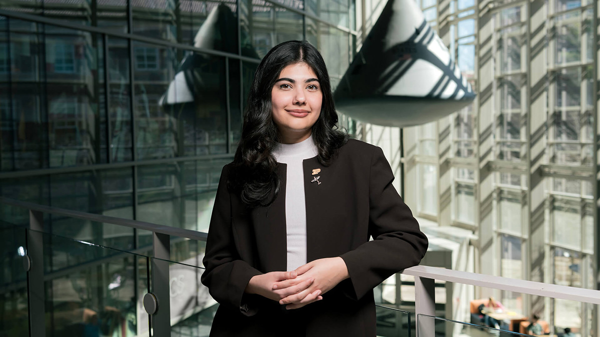 Roha Gul, a graduate student in autonomy and control with a focus in astrodynamics and space applications, joined Leading Women Toward Space Careers to learn and network. In this picture, she stands in the atrium of Armstrong Hall with the lunar capsule model in the background.