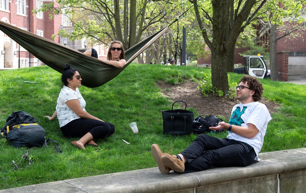 Banner image shows students studying and talking on a grassy area on Purdue University campus