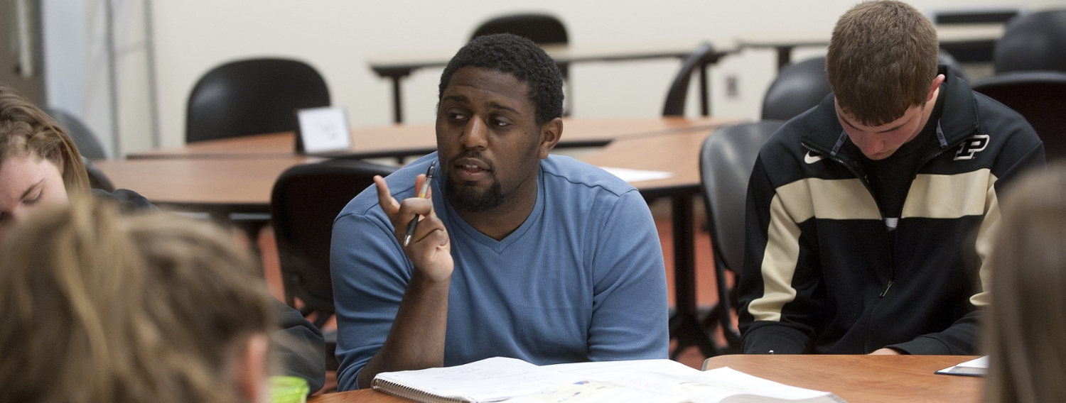 Banner image: shows man asking question at group study session