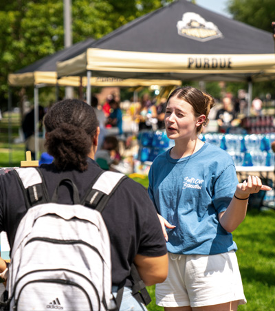 Student speaking during RHA Day to another student. 