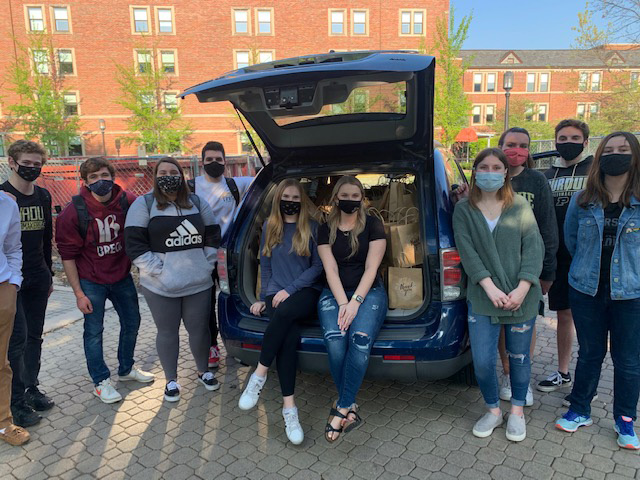 Several ALDPES members standing in front of thank you bags.