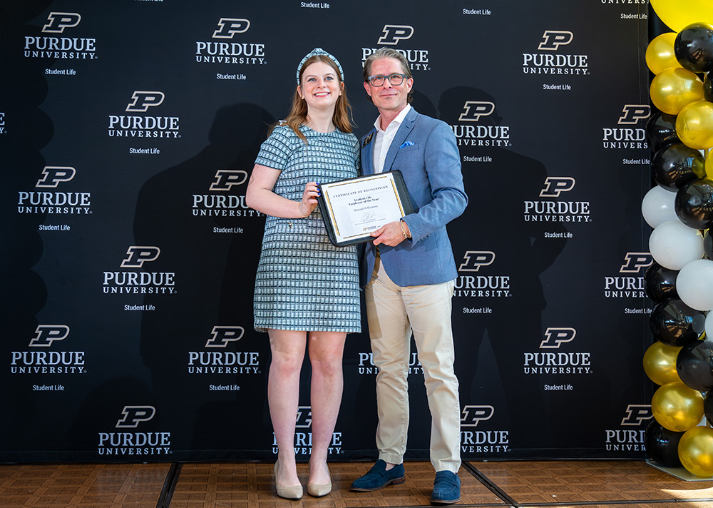 Hannah Williamson receiving an award alongside Todd Wetzel.