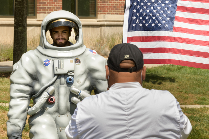 Student poses with astronaut cutout, gets picture taken
