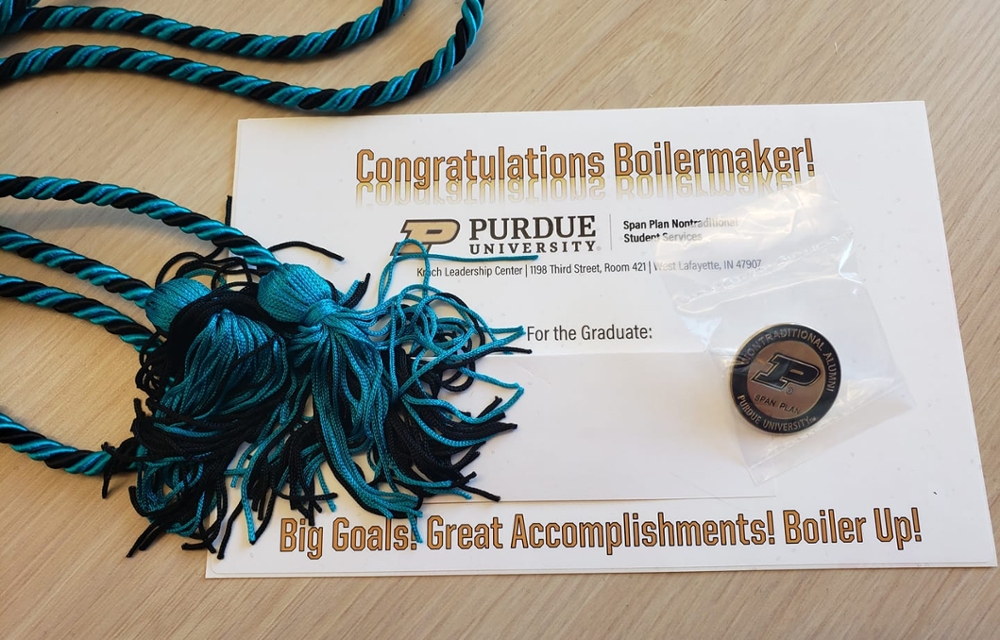 Purdue diploma and new blue Span Plan graduation cords