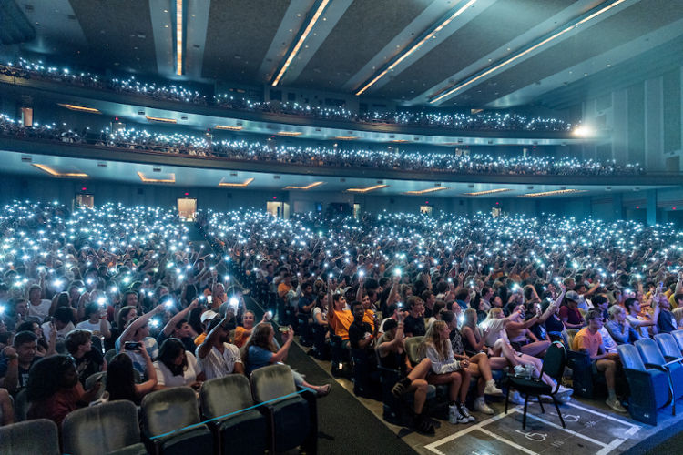 Image showing man with whiteboard marker writing, facing towards students
