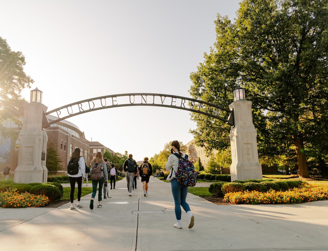 Image showing man with whiteboard marker writing, facing towards students