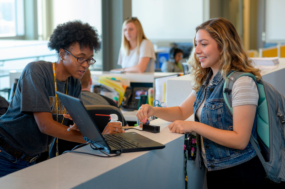 Four student success programs directors stand for a picture in Krach Leadership center