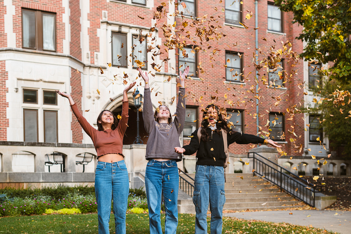 Image showing students gathered around a table outside of Krach Leadership center playing games