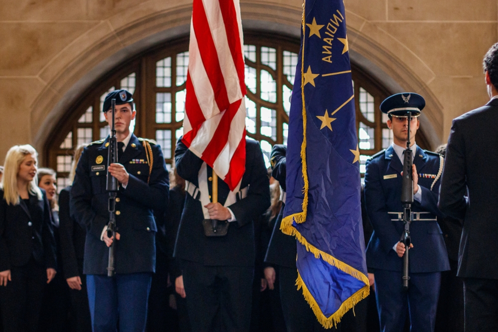 Pictured: Veterans Day celebration with members of armed services holding flags