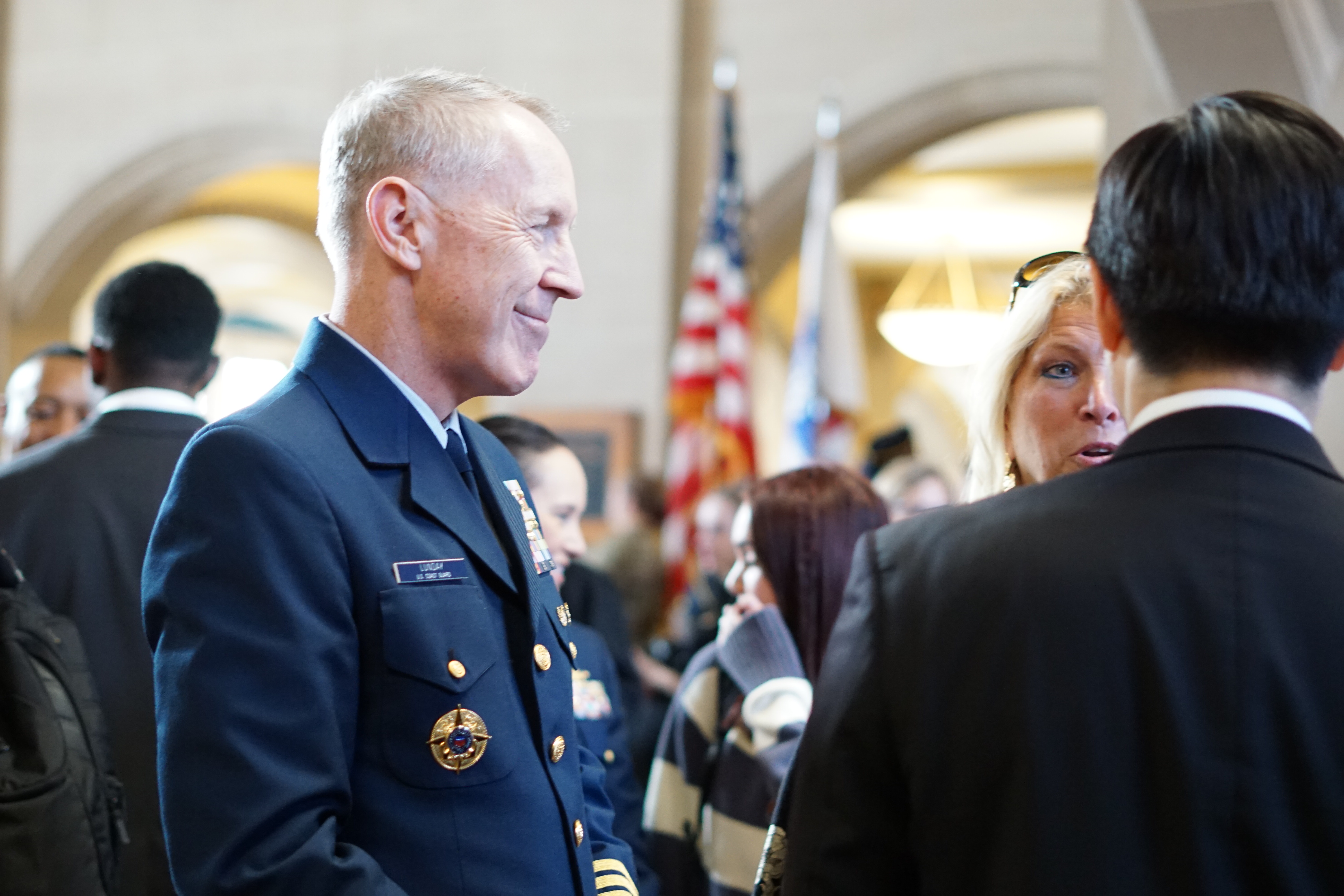 Pictured: Veterans Day celebration with members of armed services holding flags