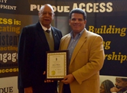 The Director of Purdue University's Office of Supplier Diversity Development, Jesse Moore, receives special recognition for thirteen years of meritorious service. Jesse was also honored with a Distinguished Citizen Award from the City of Lafayette.