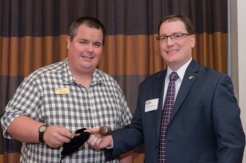 Bol receives gavel from Denny Darrow.