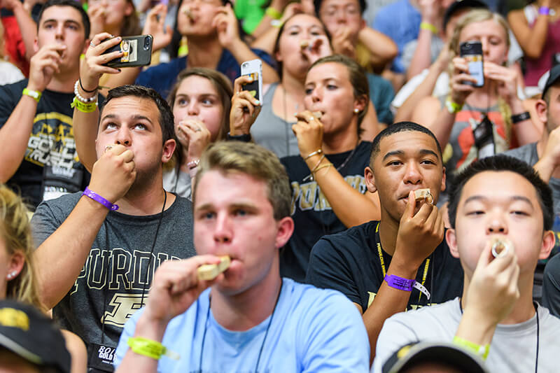 Purdue students blowing train whistles