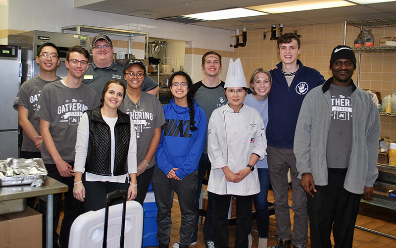 Members of student group Timmy Global Health and The Gathering Place staff