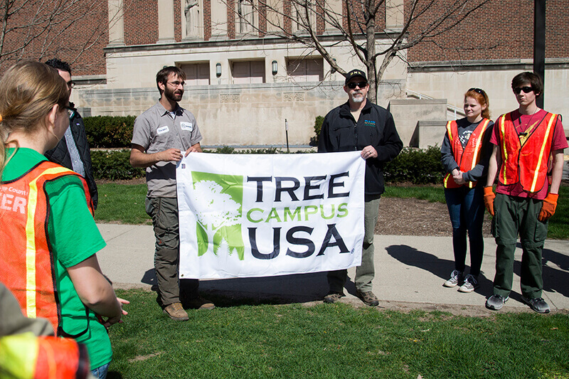 Kristopher Brown accepts flag from Ryan Bowser