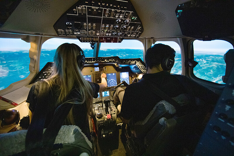 Professional flight students in flight simulator