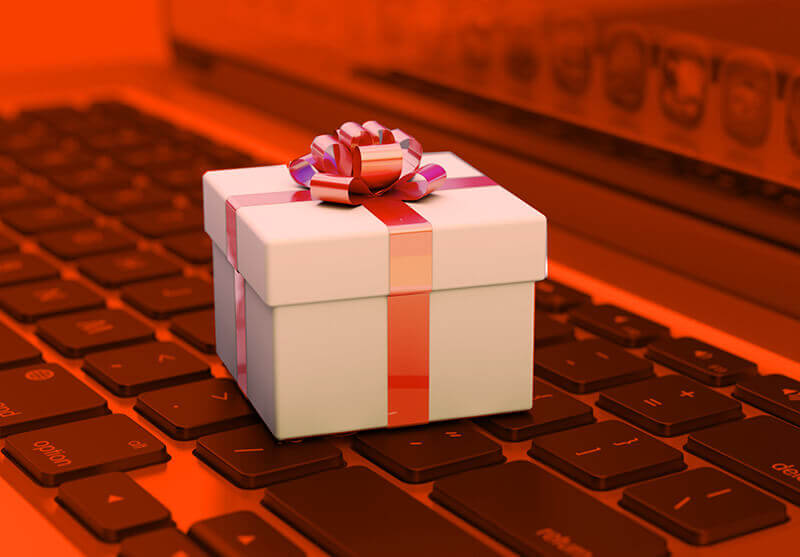 box with ribbon and bow, sitting on keyboard