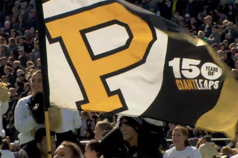 Purdue 150 flag at football game